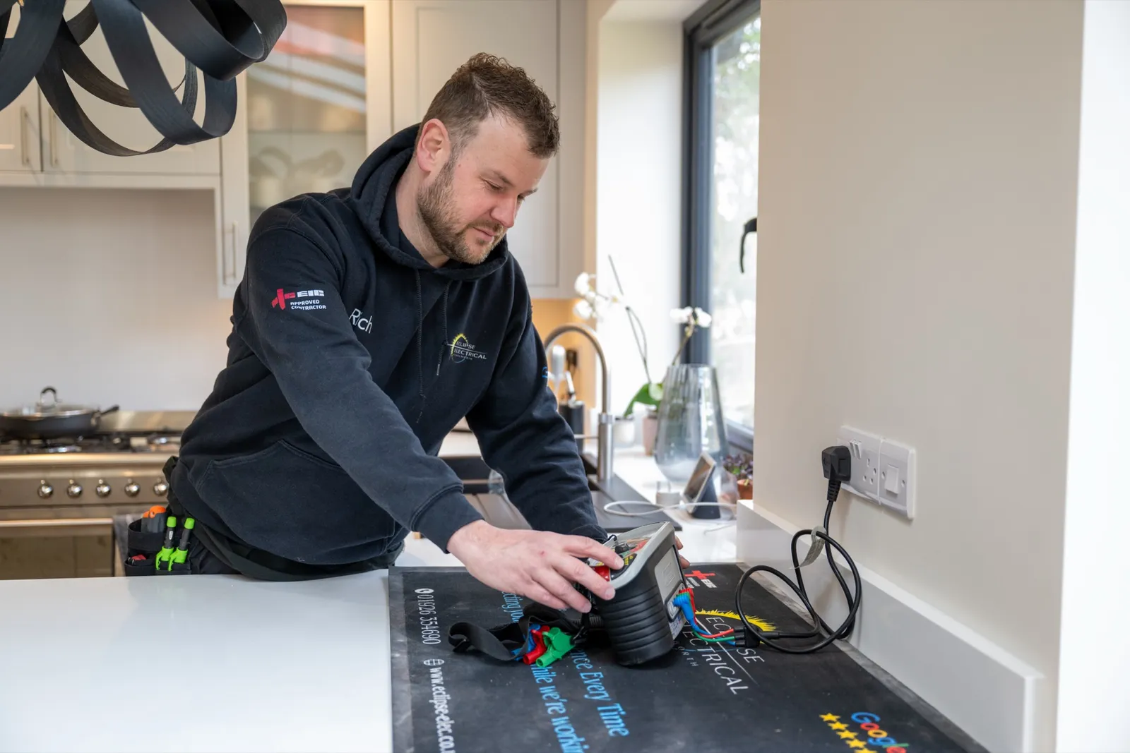 Electrician carrying out an EICR inspection inside a Warwickshire home