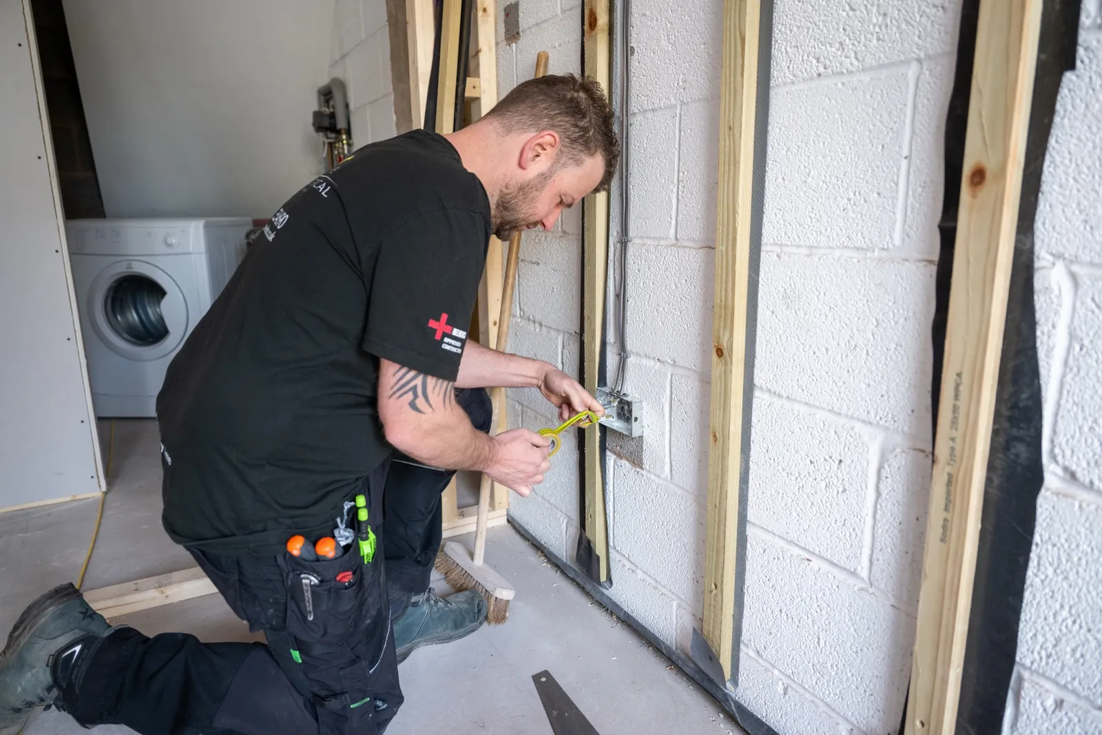 Electrician inspecting older wiring inside a Warwickshire property